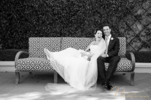 Bride and groom on bench laughing, La Valencia Wedding Photography, San Diego wedding photograher