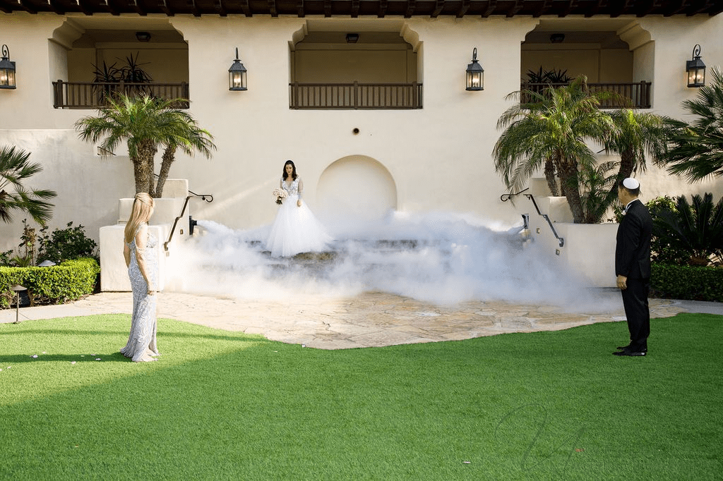 A La Jolla Wedding Photographer captures a bride stepping from smoke at an elegant ceremony.