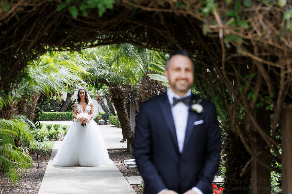 A bride approaches the groom for a first look, shot by a La Jolla Wedding Photographer.
