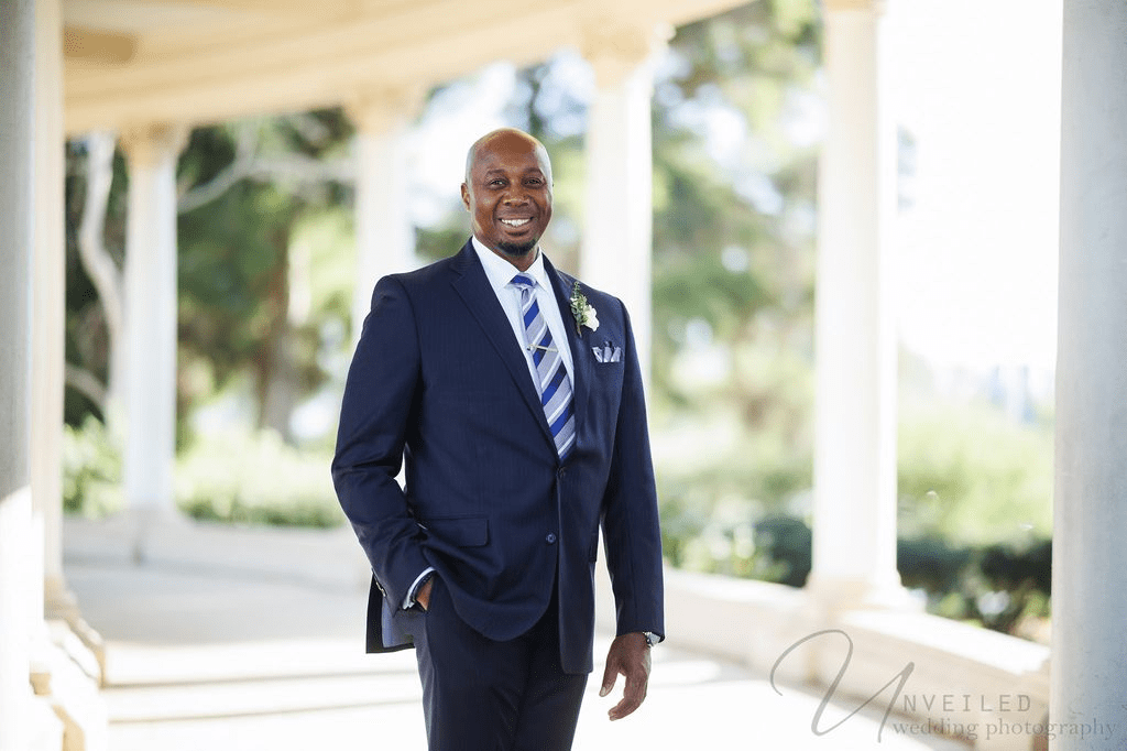 Smiling groom in a blue suit for San Diego Courthouse Wedding Photography outdoors.