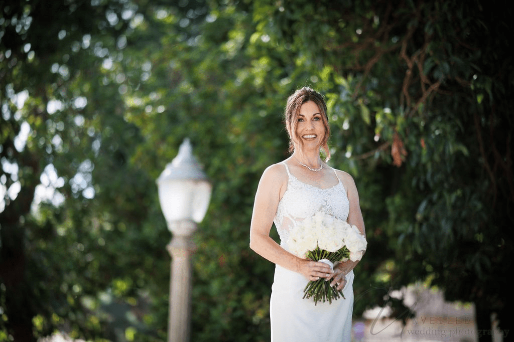 A bride smiles on her big day with San Diego Courthouse Wedding Photography by Unveiled.