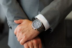 Groom adjusting his wristwatch before the ceremony at one of the most elegant Wedding Venues in San Diego
