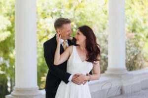 A joyful bride and groom sharing a candid laugh outdoors, captured by a San Diego wedding photographer as one of the must-have wedding photos for their album.