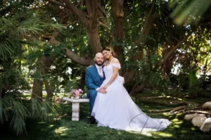 Bride and groom sitting in a garden at small wedding venues in San Diego.