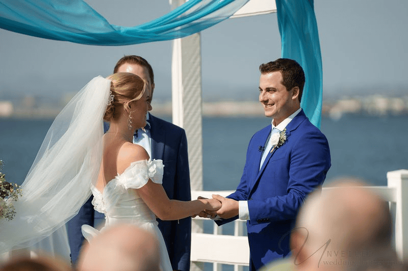Bride and groom holding hands at alter for Wedding Photography Contract.