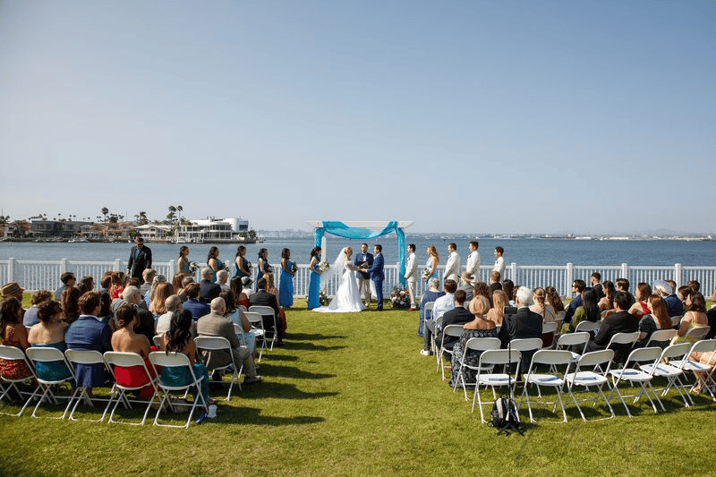 Outdoor wedding ceremony by water for Wedding Photography Contract.