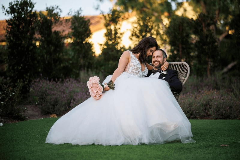 Bride holding pink roses in an Estancia La Jolla wedding photography session.
