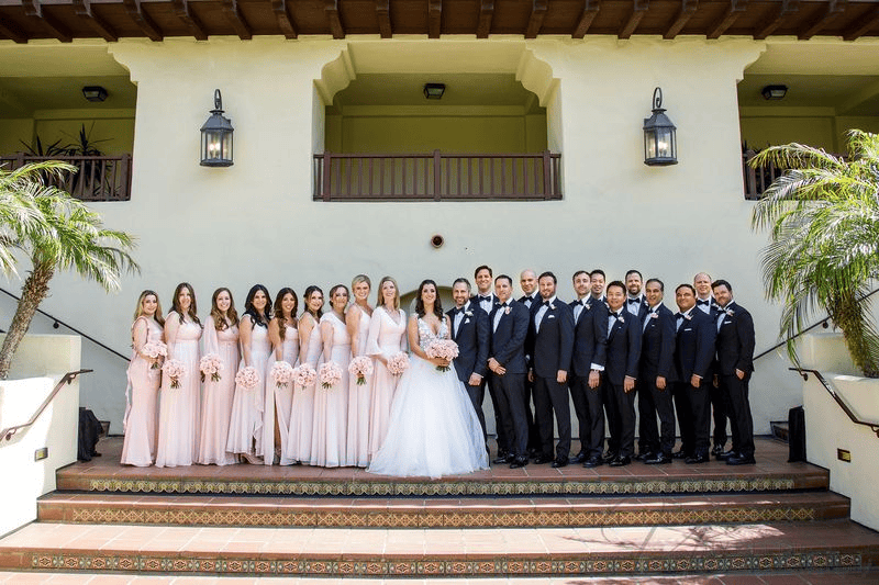 Wedding party in pink gowns and black tuxedos during an Estancia La Jolla wedding photography session.
