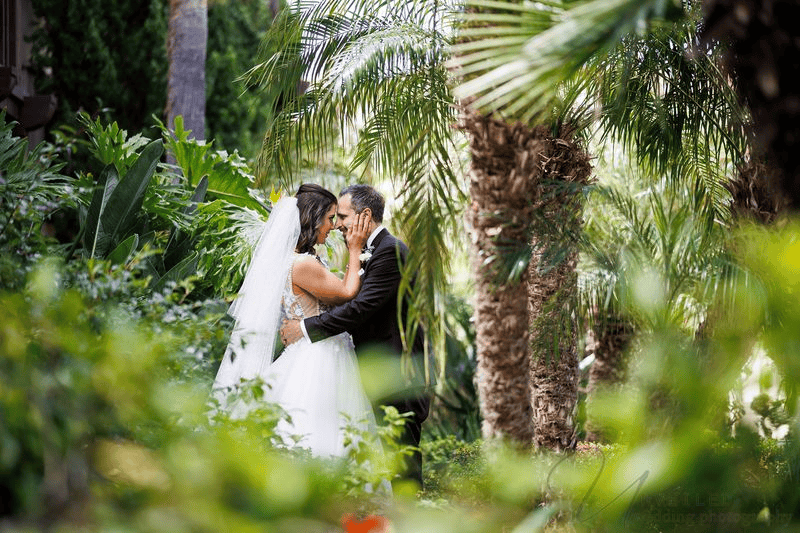 Romantic Estancia La Jolla wedding photography with a bride and groom embracing.
