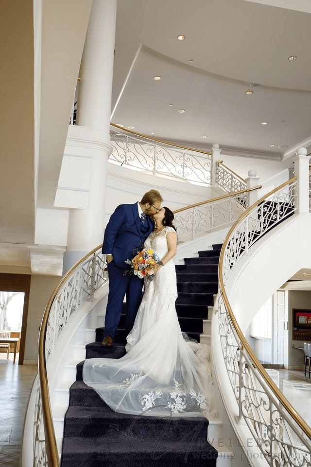 Couple holding each other closely during a pose for wedding photos session