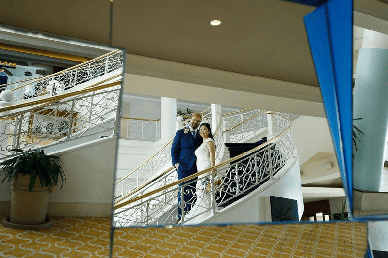 Newlywed couple walking hand in hand to pose for wedding photos