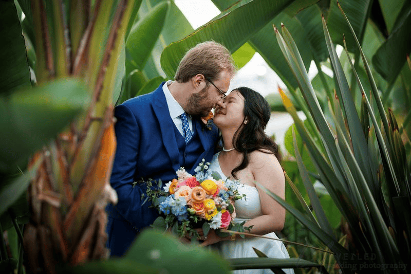 Bride and groom creating candid moments as they pose for wedding photos.