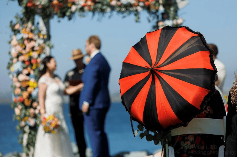 Couple sharing a romantic embrace as they pose for wedding photos outdoors