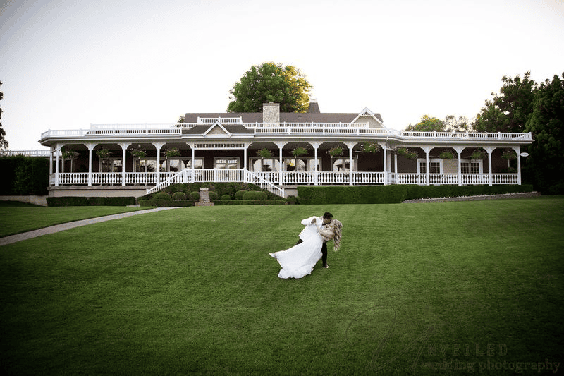Bride and groom dipping on the lawn at Grand Tradition Fallbrook.