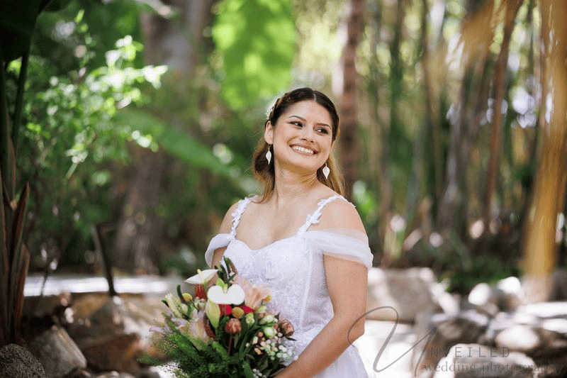 Smiling bride with bouquet at small wedding venues in San Diego.