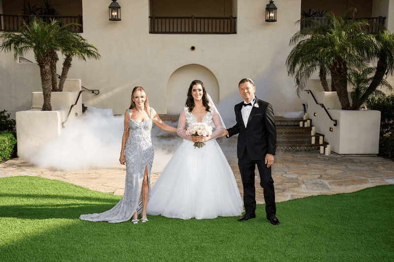Bride posing with parents, a key portrait for a Wedding Photography Shot List.