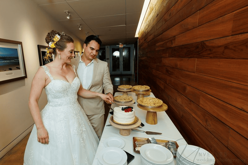 Bride and groom cutting cake, a classic moment for a Wedding Photography Shot List.