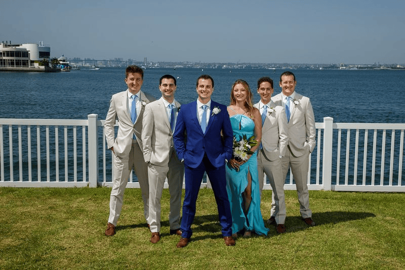 Groom and groomsmen posing by the bay during an intimate wedding in San Diego.