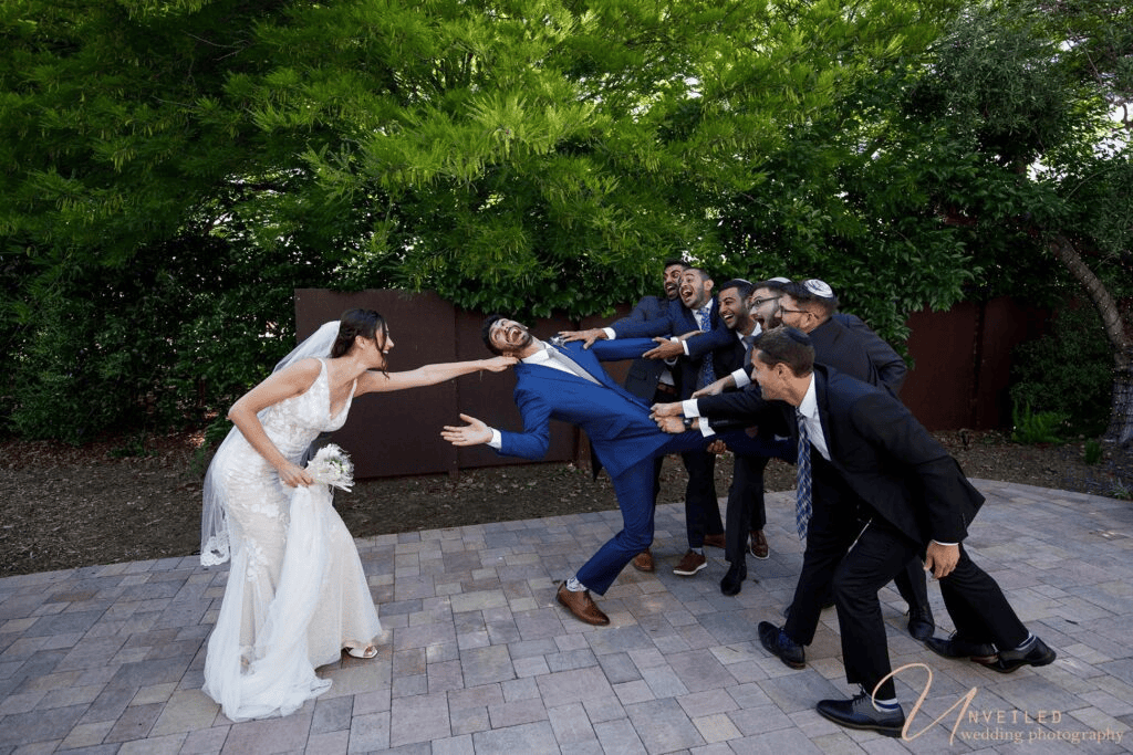 Fun wedding party tug-of-war photo for Wedding Album vs Digital Gallery selection.