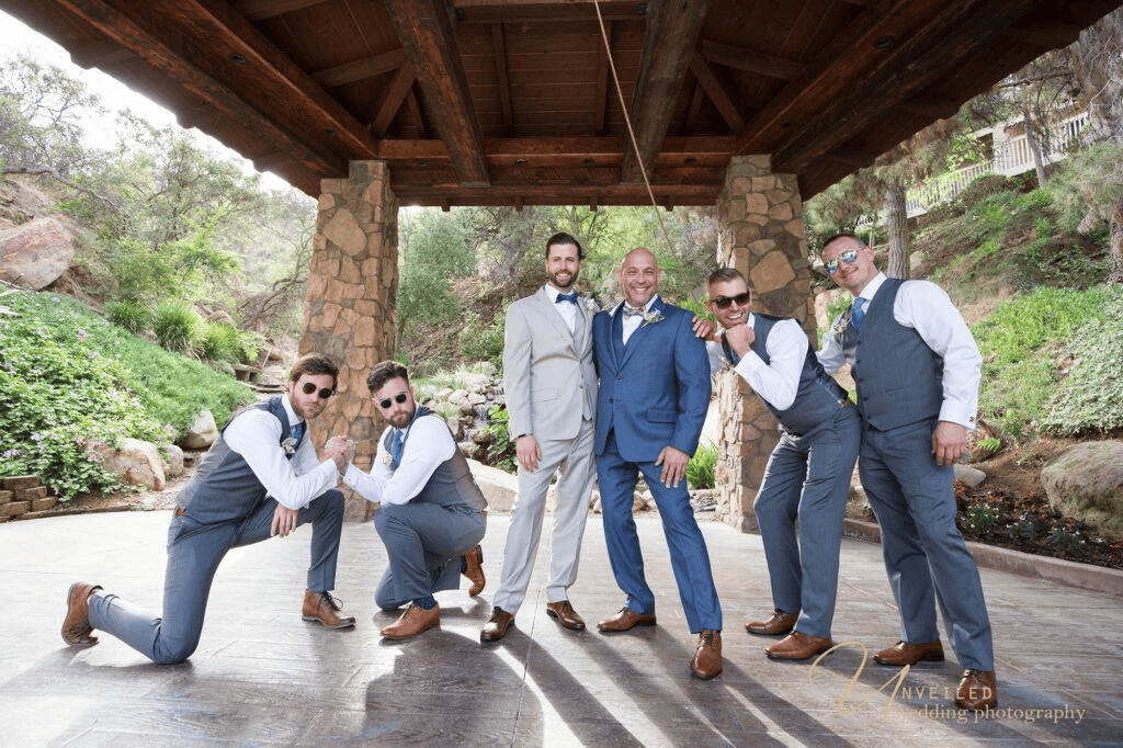 Fun groomsmen group photo under gazebo by same-sex wedding photographer in San Diego.