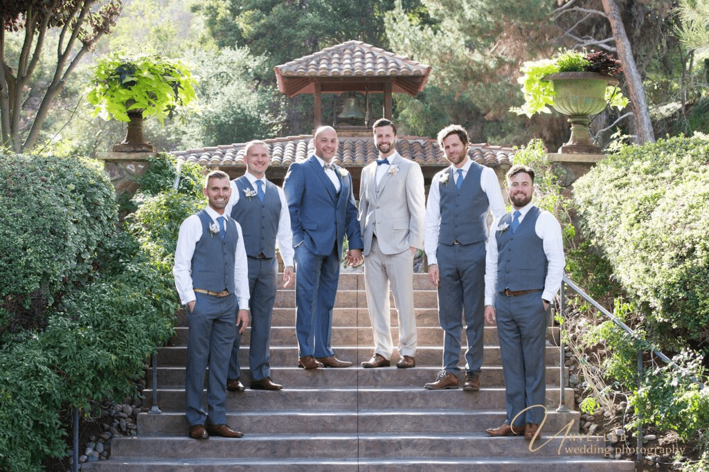 Wedding party pose on outdoor stairs by same-sex wedding photographer in San Diego.