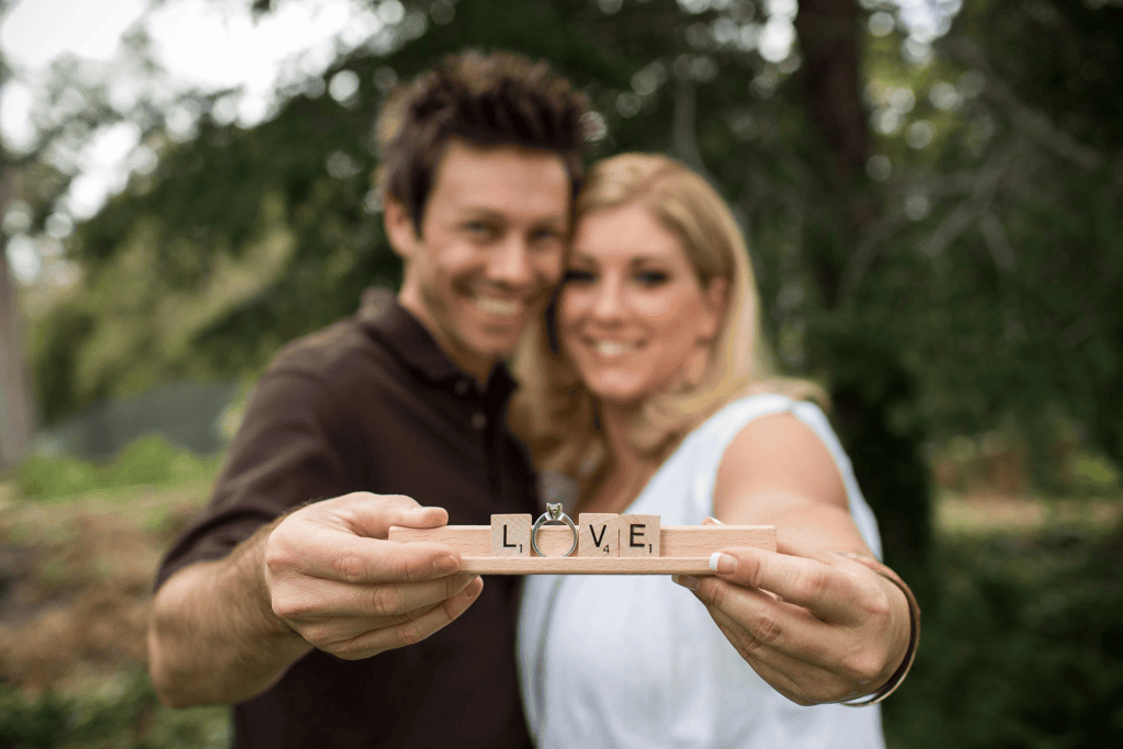 Couple holding Scrabble letters spelling LOVE for an engagement session before your wedding.
