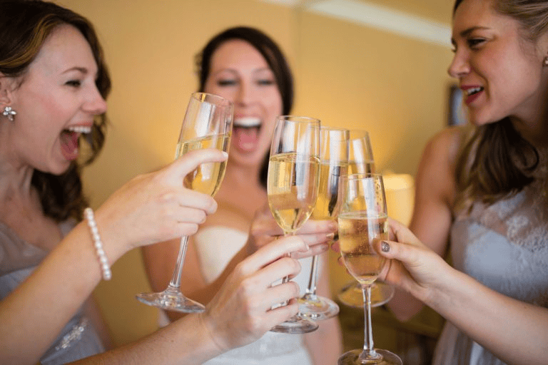 Bridesmaids clinking champagne flutes for Wedding Photography Trends 2027.