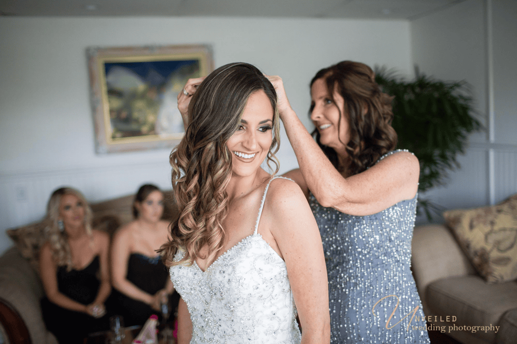 Mother adjusting bride hair captured by Grand Tradition Estate Wedding Photographer.