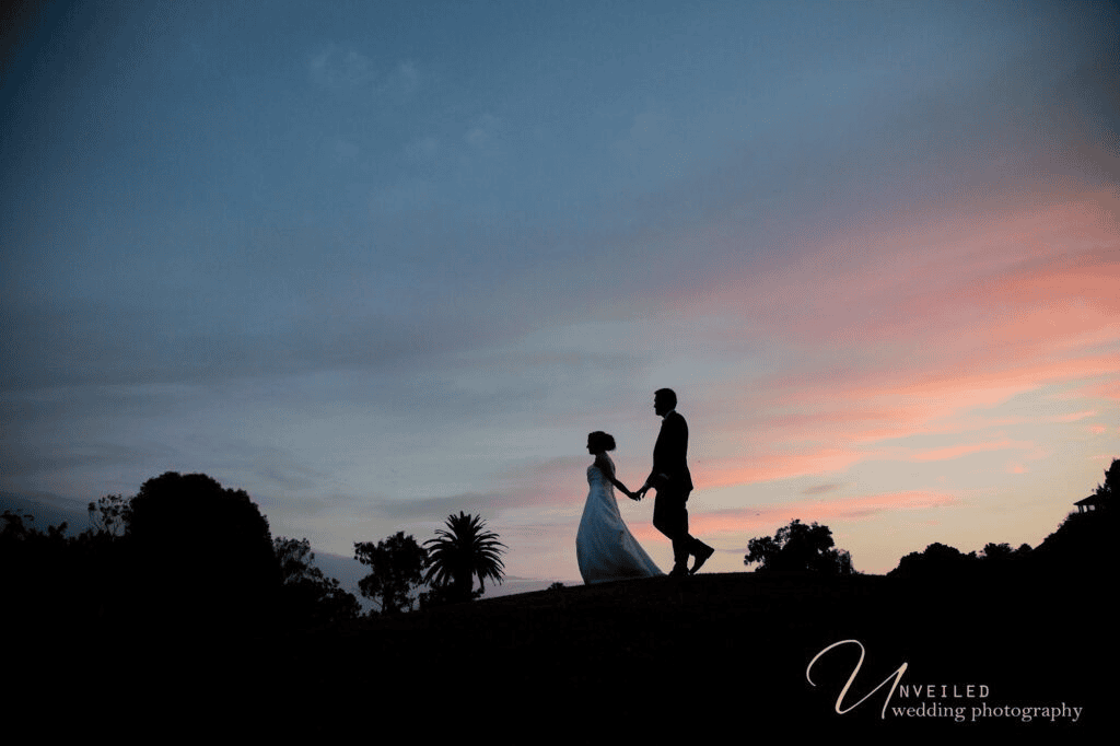 Sunset silhouette of bride and groom in fine art vs documentary wedding photography.